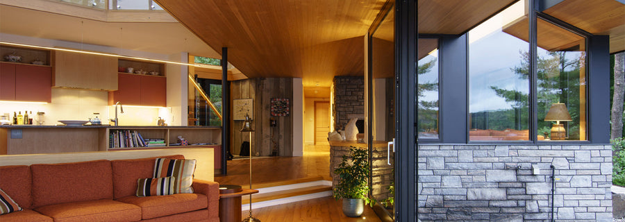 an interior view with midcentury modern furniture and northern wide wood planks on the floor