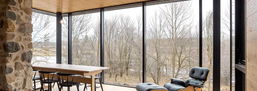 an interior view with midcentury modern furniture and northern wide wood planks on the floor