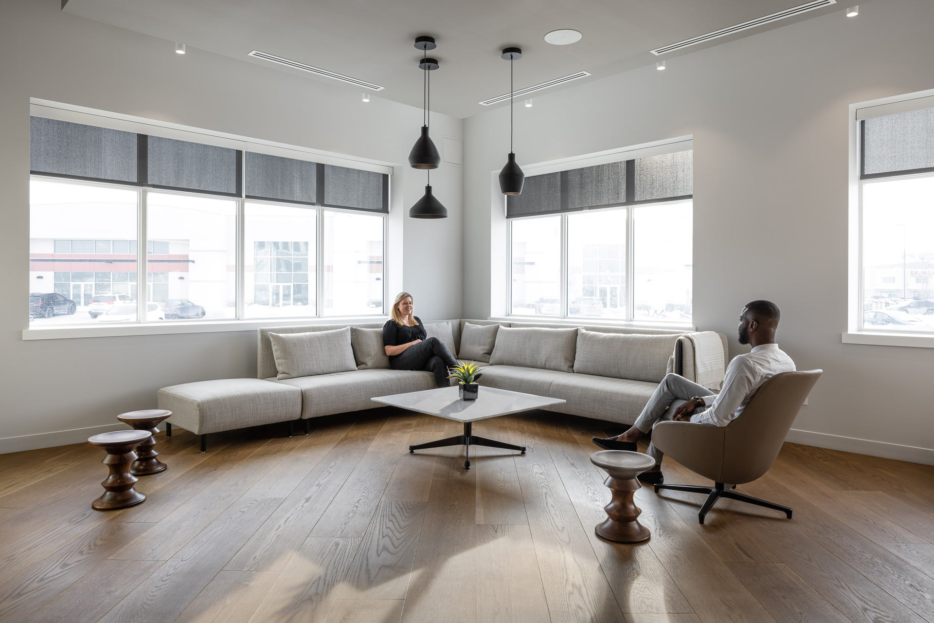 an interior view with midcentury modern furniture and northern wide wood planks on the floor