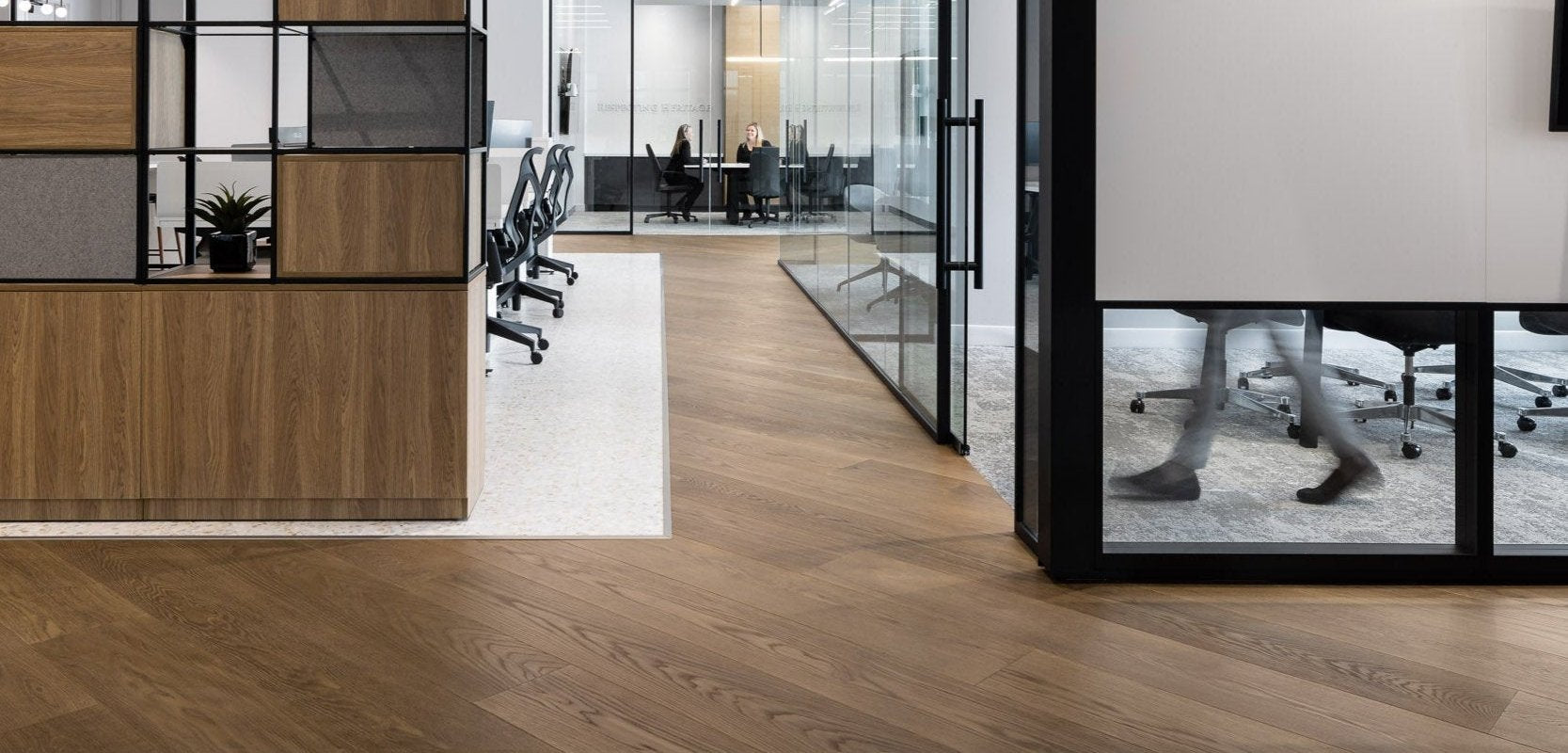 an interior view with midcentury modern furniture and northern wide wood planks on the floor