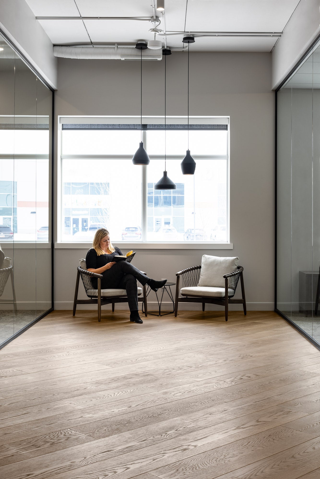 an interior view with midcentury modern furniture and northern wide wood planks on the floor