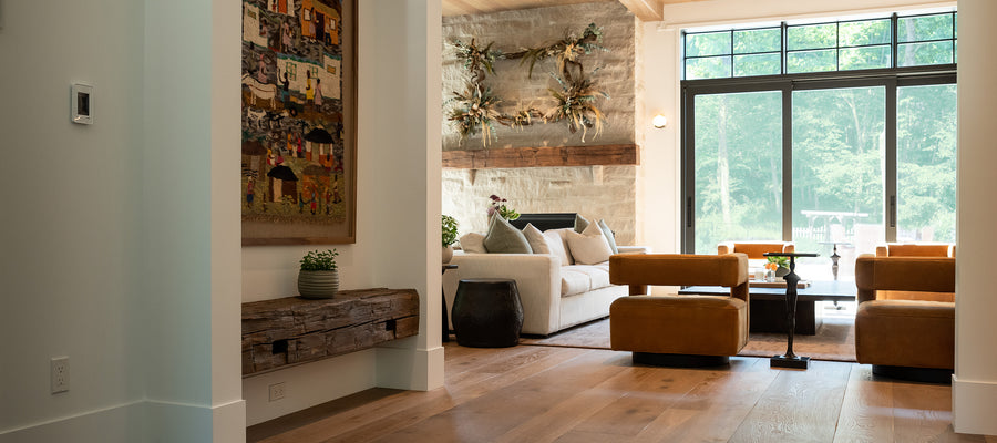 an interior view with midcentury modern furniture and northern wide wood planks on the floor