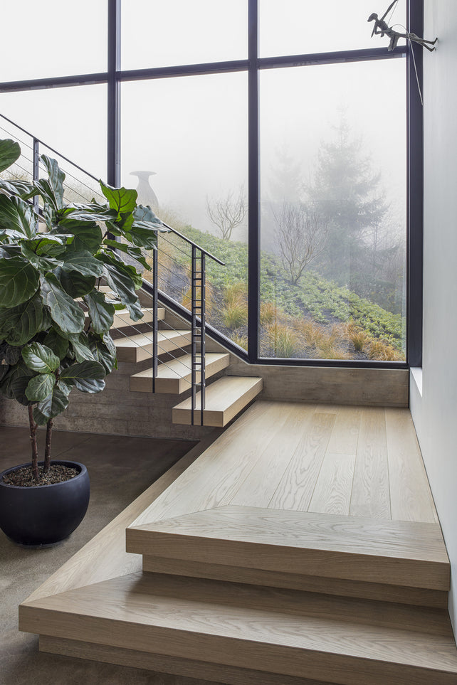 an interior view with midcentury modern furniture and northern wide wood planks on the floor