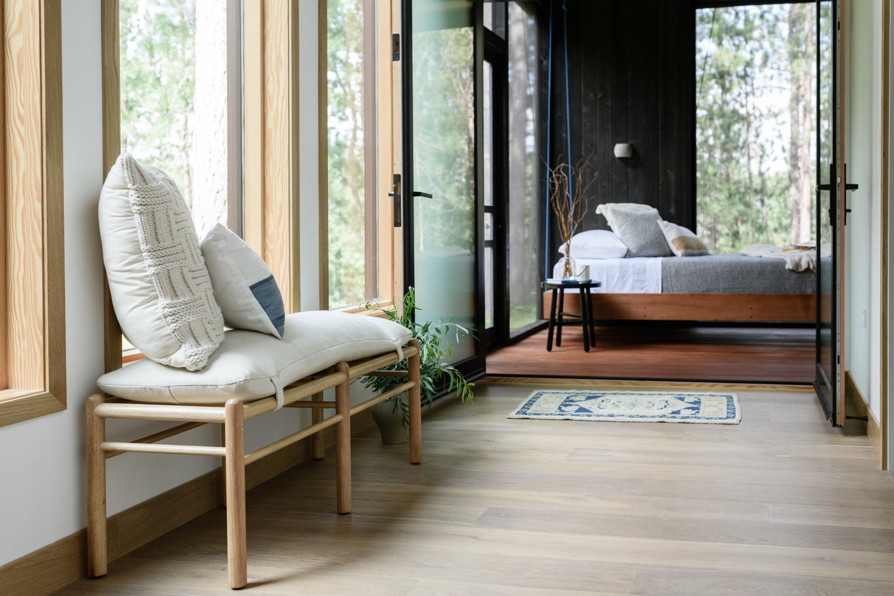 an interior view with midcentury modern furniture and northern wide wood planks on the floor