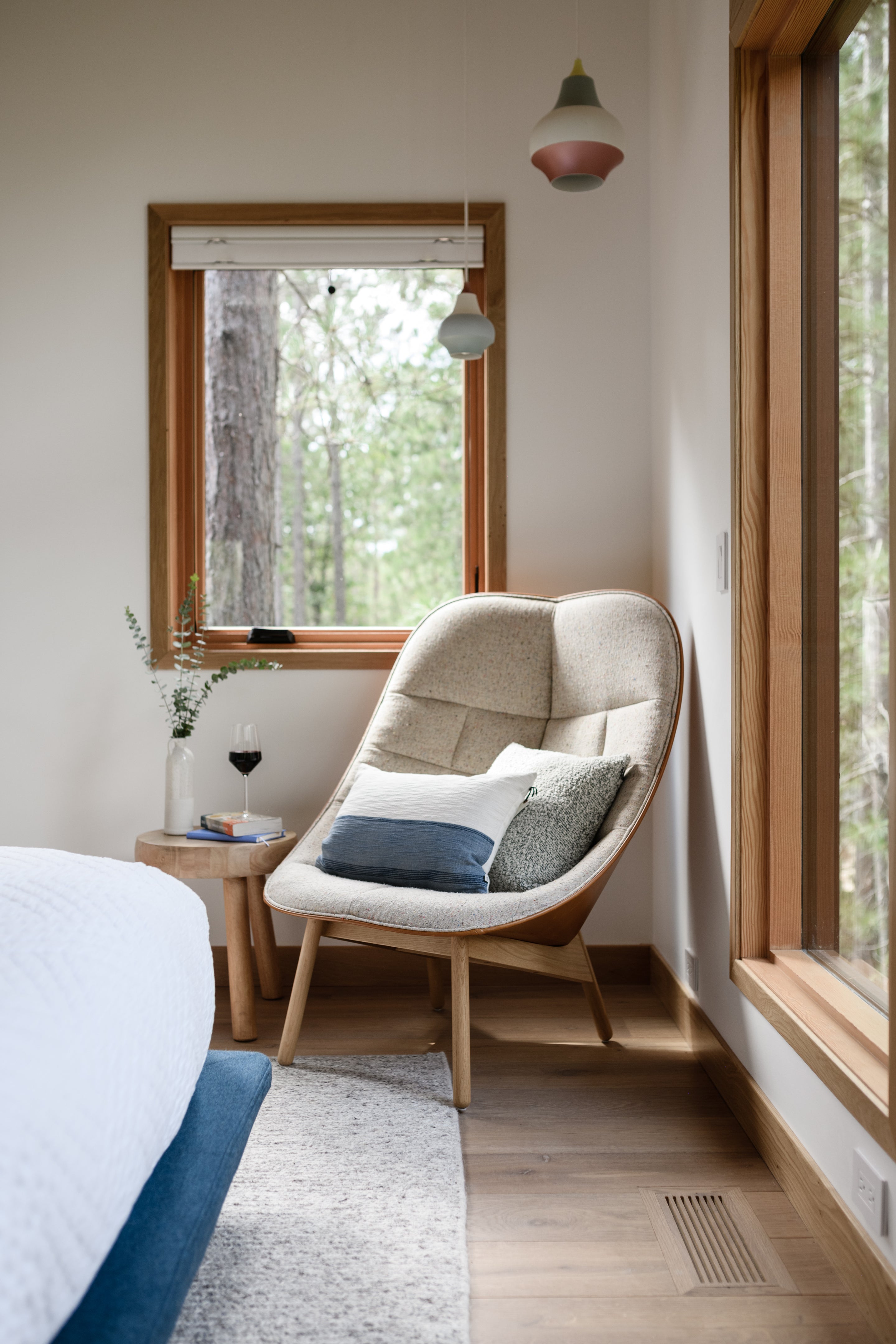 an interior view with midcentury modern furniture and northern wide wood planks on the floor