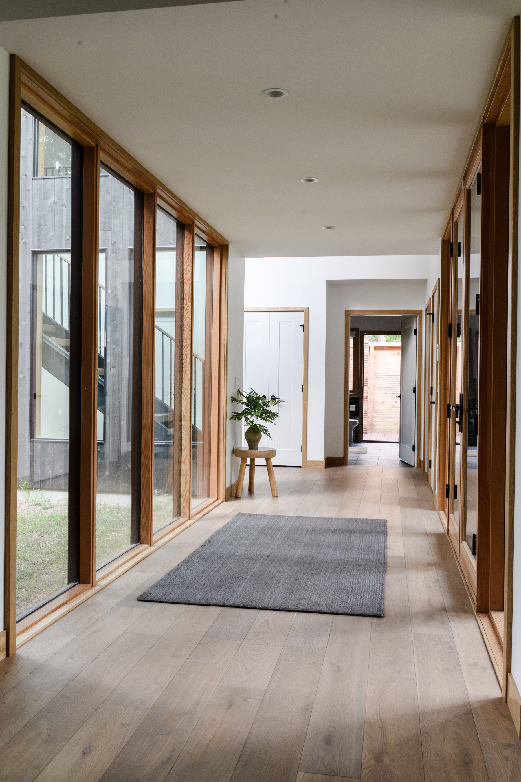 an interior view with midcentury modern furniture and northern wide wood planks on the floor