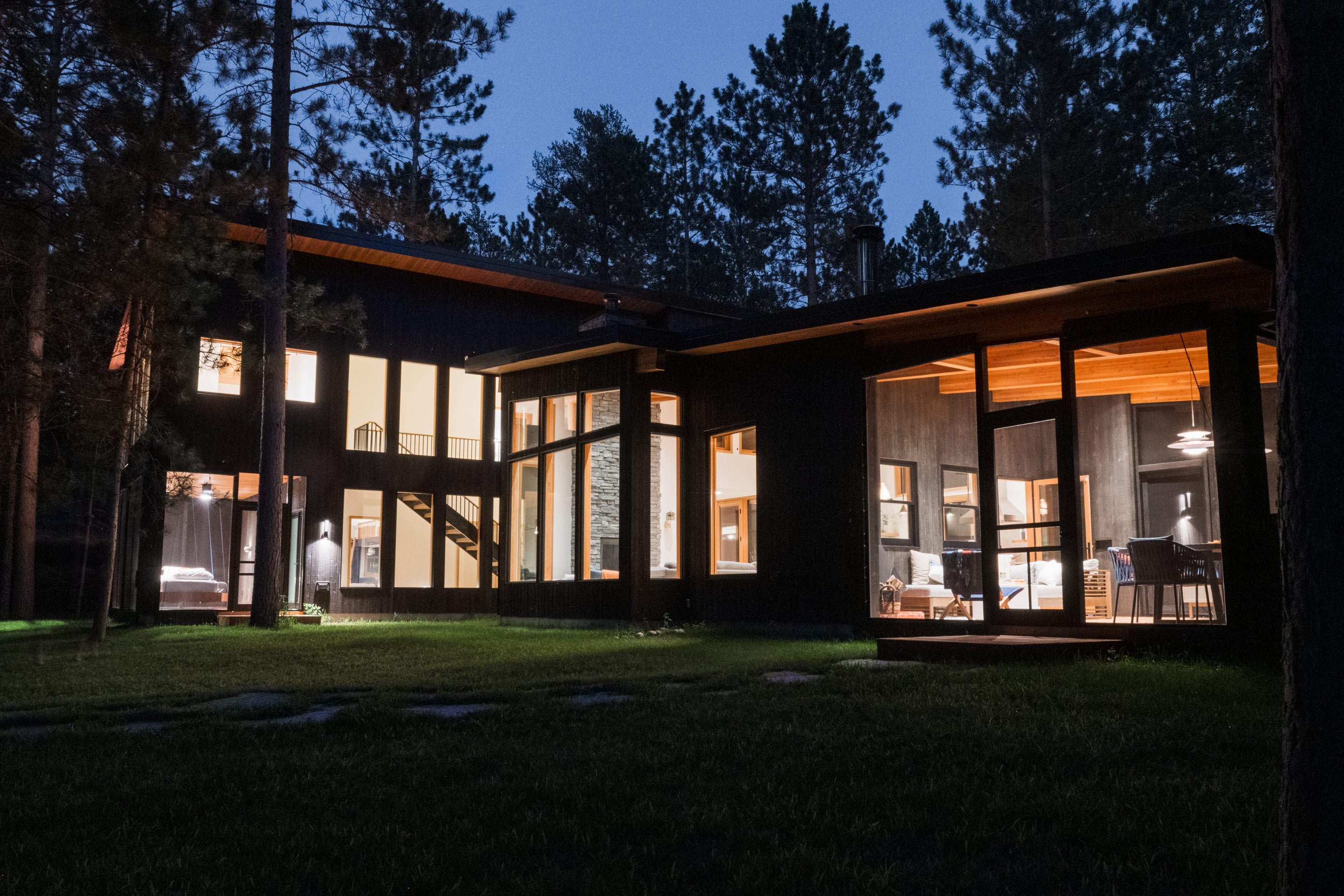 an interior view with midcentury modern furniture and northern wide wood planks on the floor