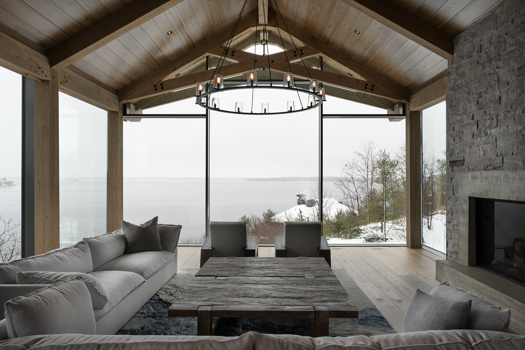 an interior view with midcentury modern furniture and northern wide wood planks on the floor