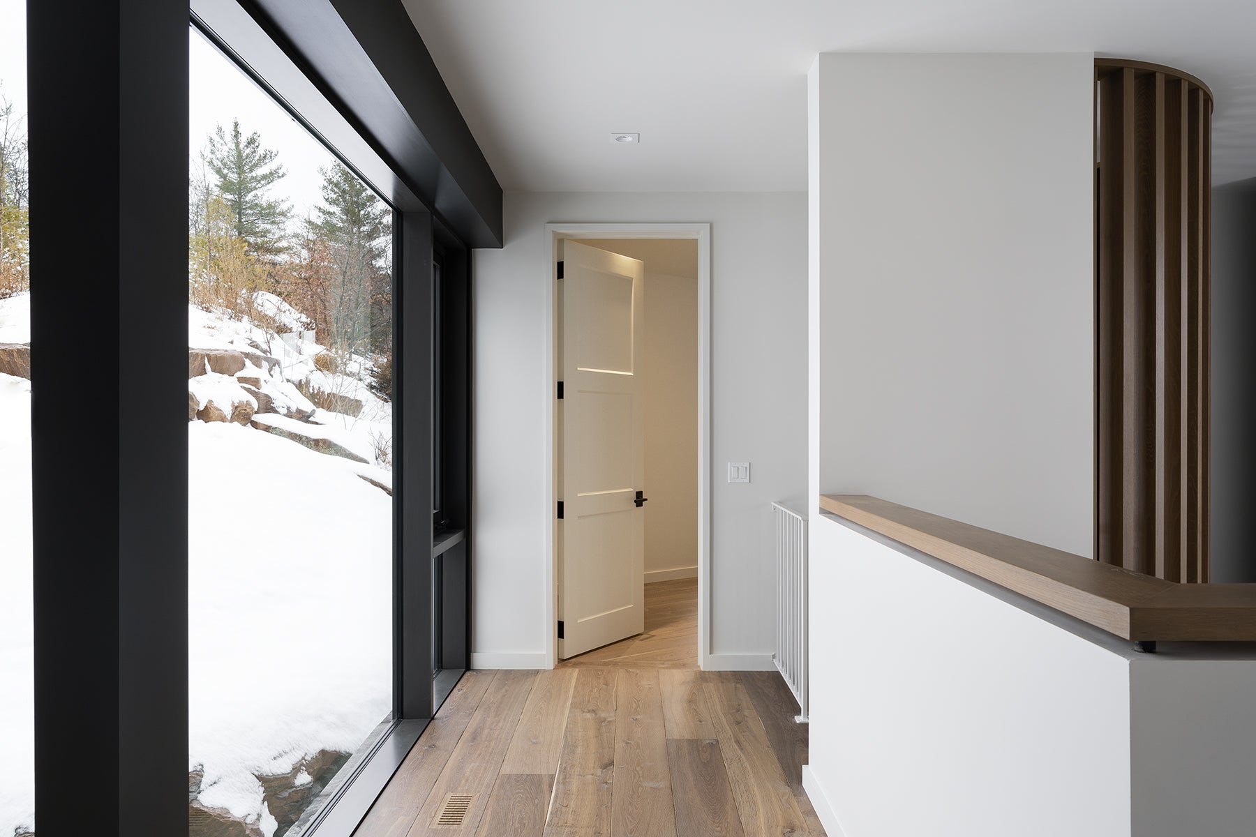 an interior view with midcentury modern furniture and northern wide wood planks on the floor