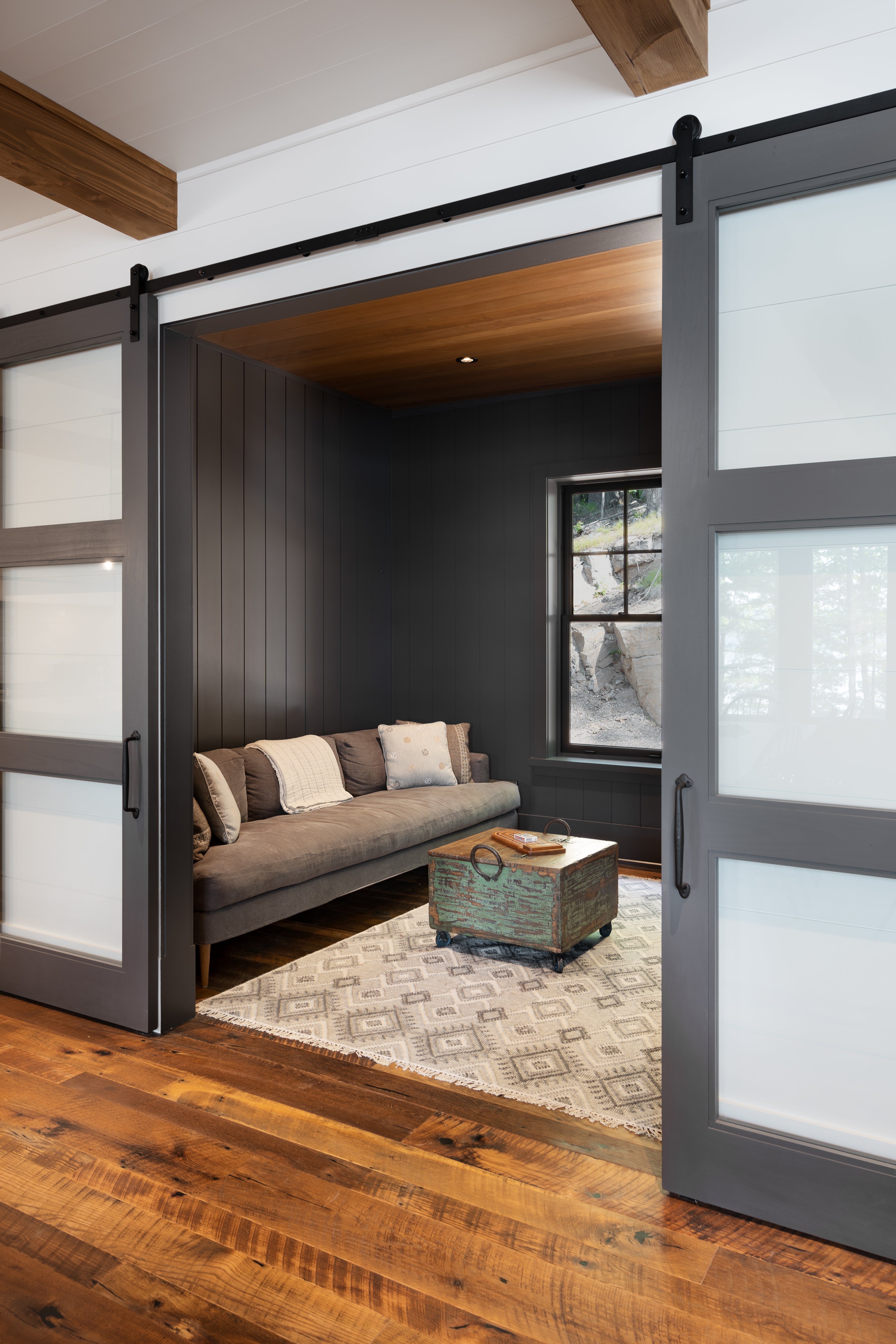 an interior view with midcentury modern furniture and northern wide wood planks on the floor