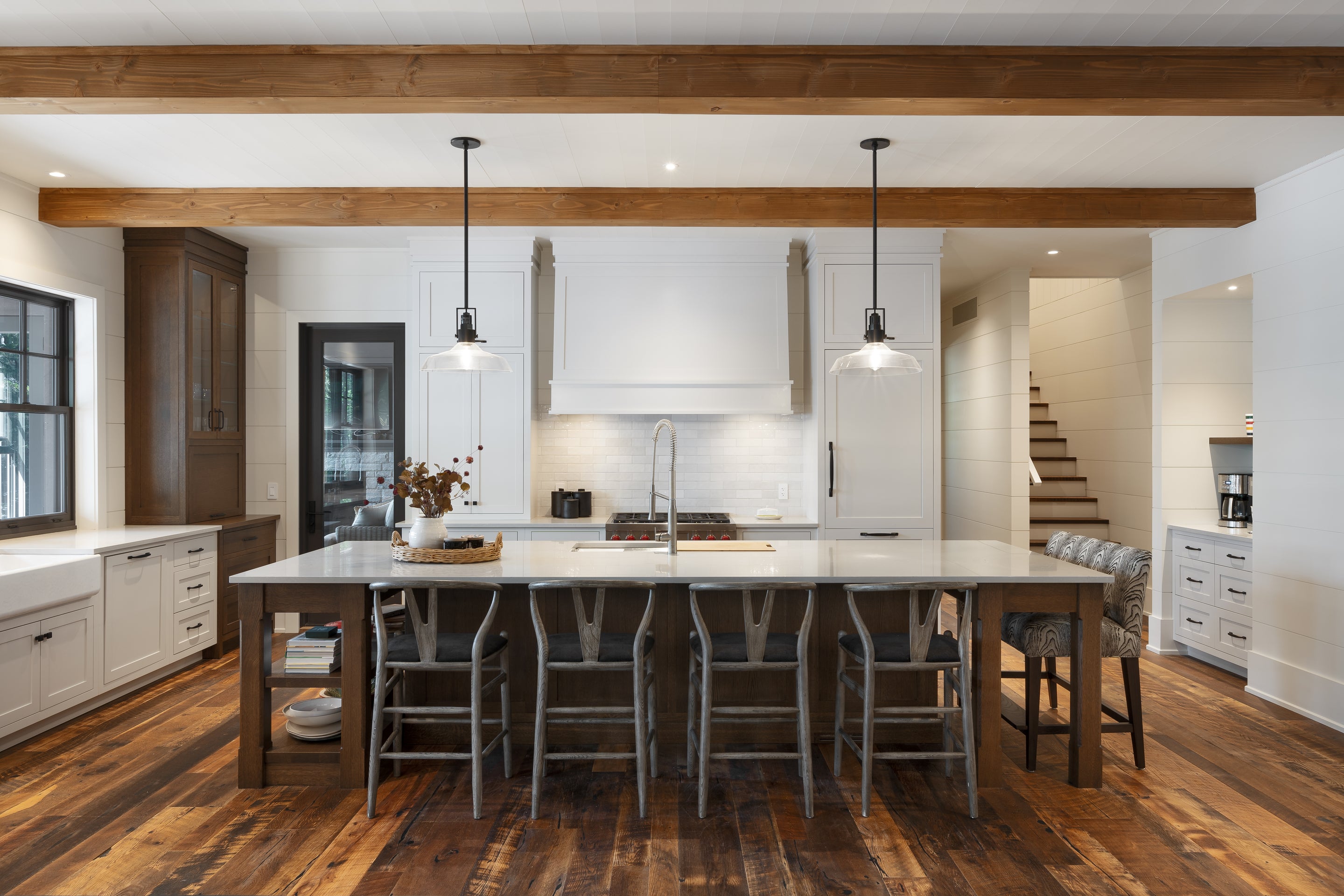 an interior view with midcentury modern furniture and northern wide wood planks on the floor