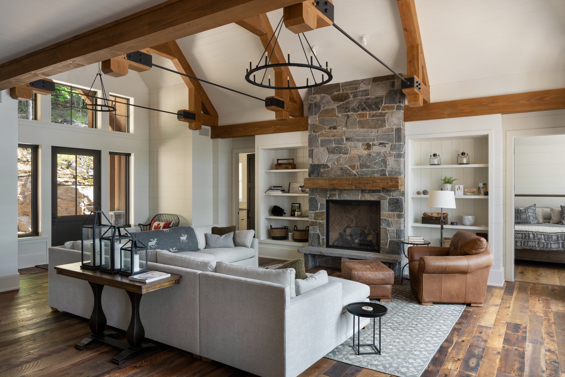 an interior view with midcentury modern furniture and northern wide wood planks on the floor