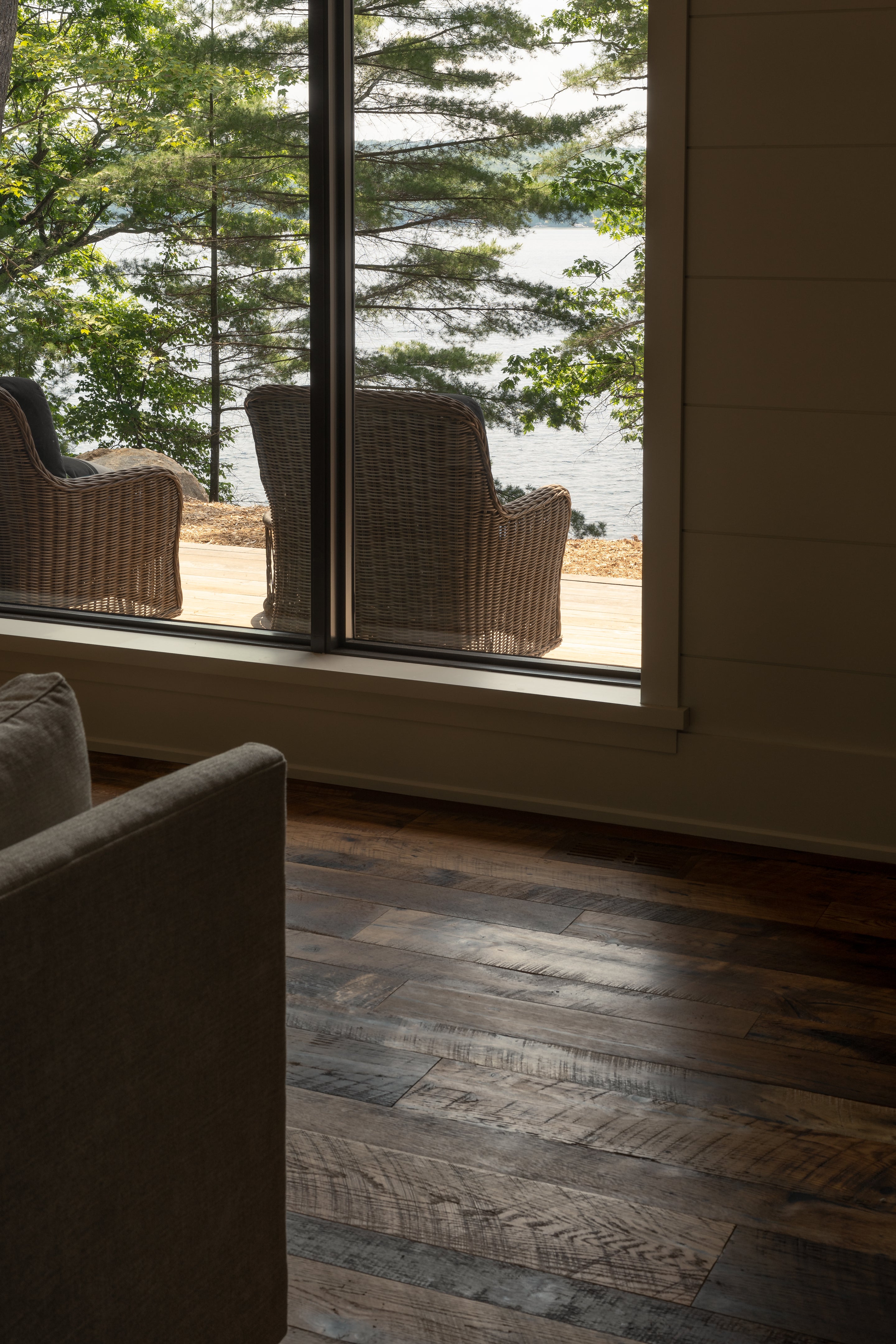 an interior view with midcentury modern furniture and northern wide wood planks on the floor