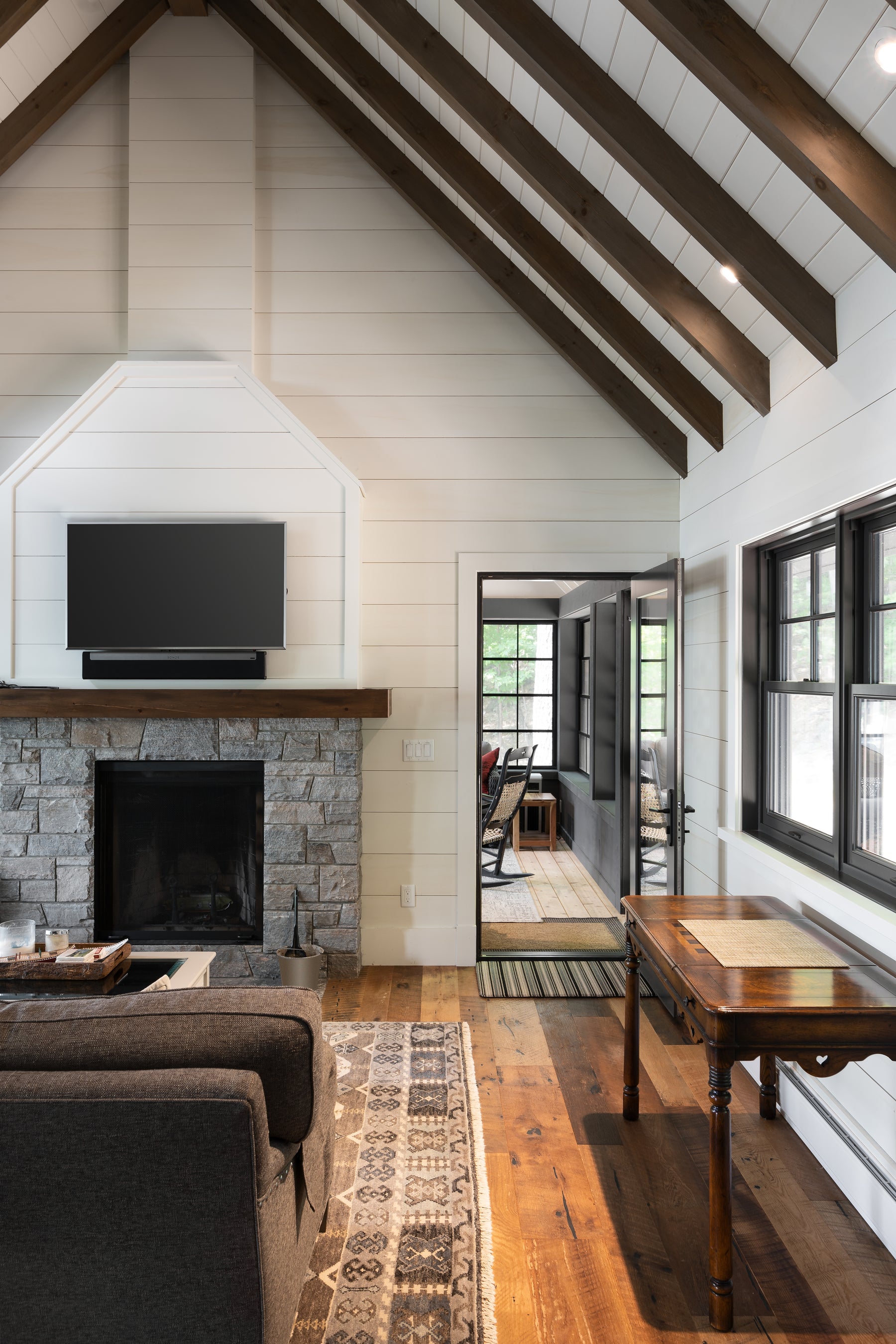 an interior view with midcentury modern furniture and northern wide wood planks on the floor