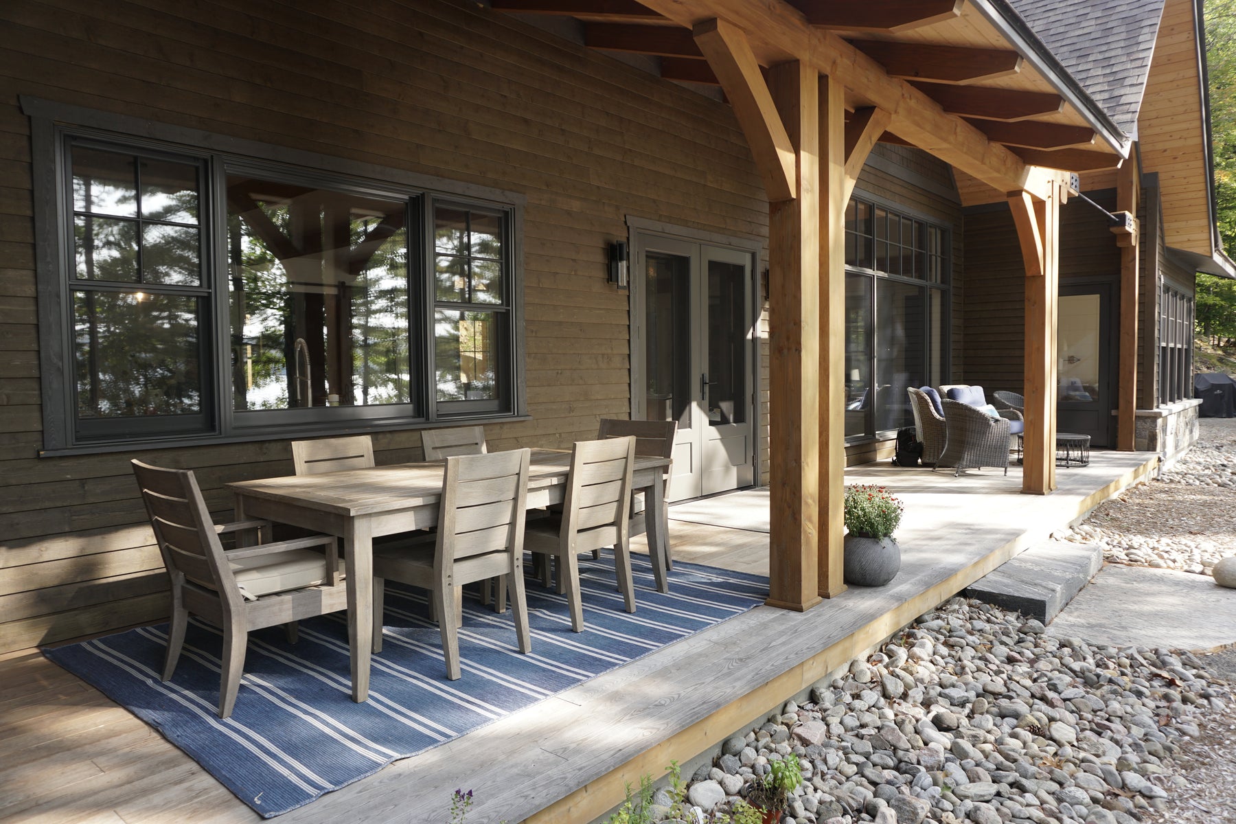 an interior view with midcentury modern furniture and northern wide wood planks on the floor