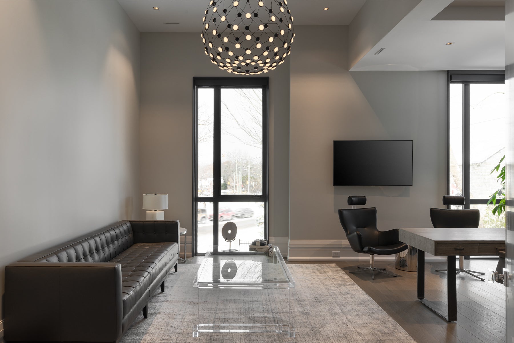 an interior view with midcentury modern furniture and northern wide wood planks on the floor