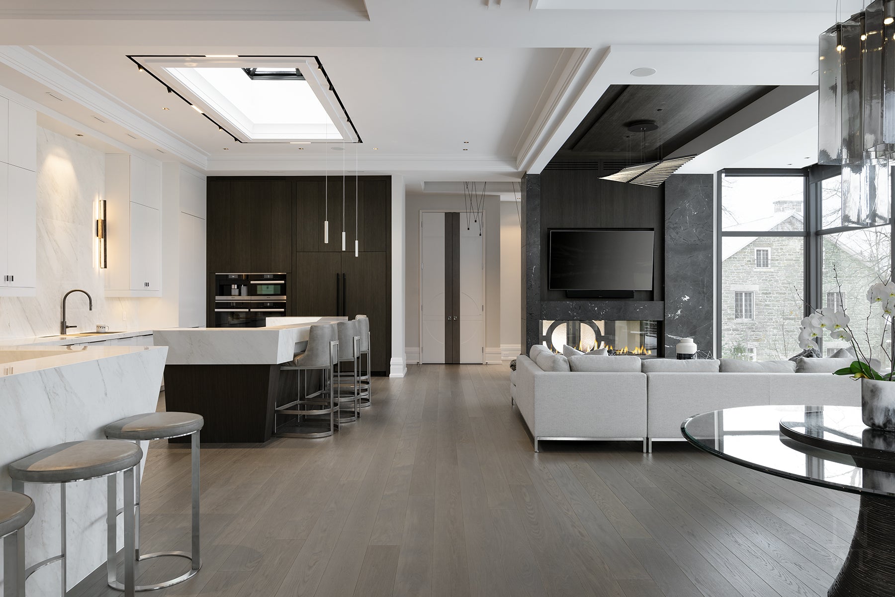 an interior view with midcentury modern furniture and northern wide wood planks on the floor