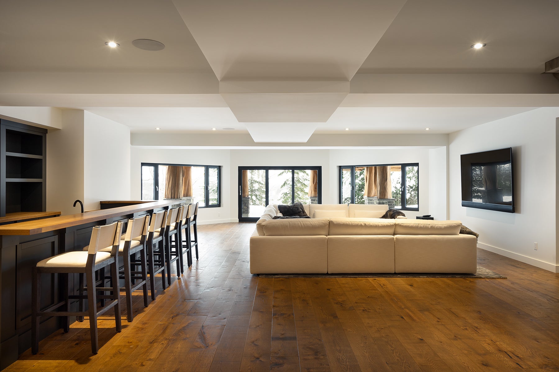 an interior view with midcentury modern furniture and northern wide wood planks on the floor