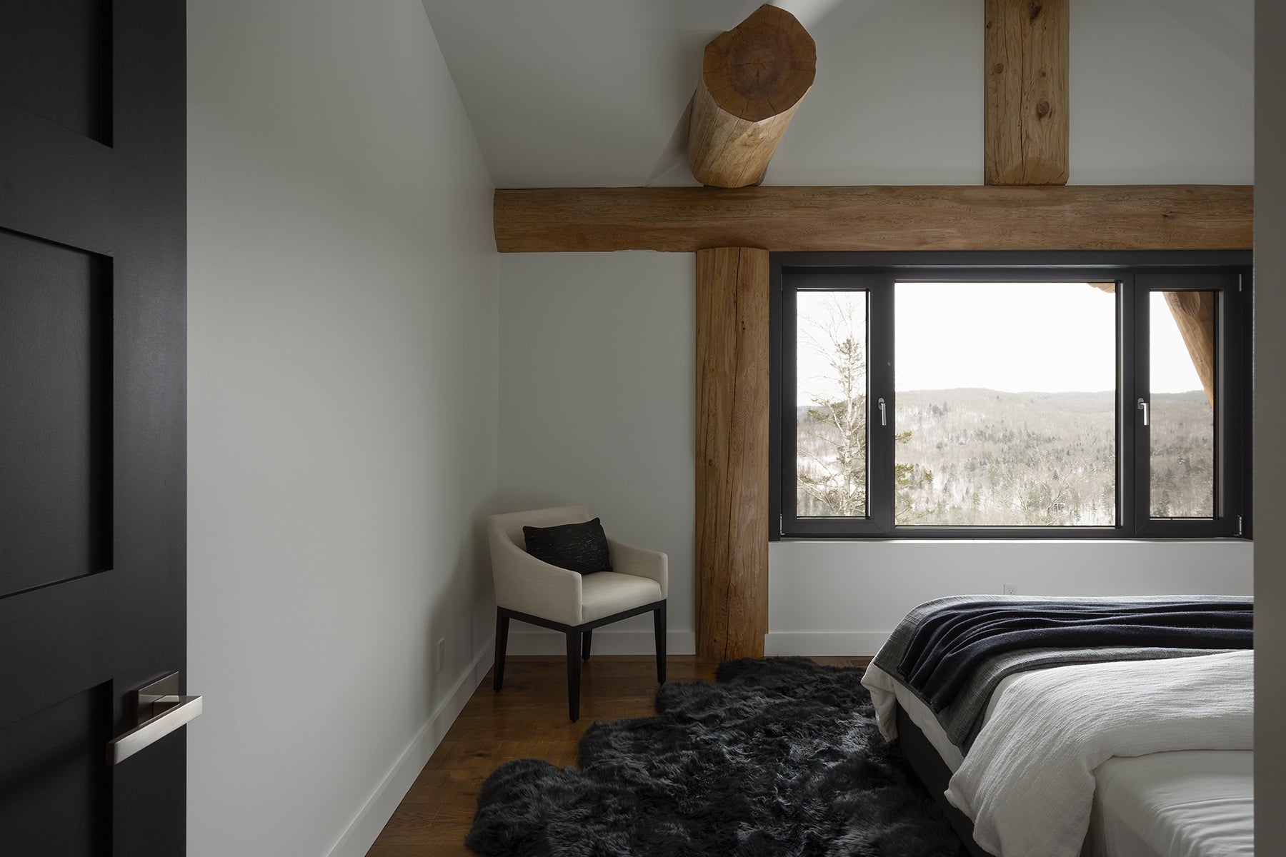 an interior view with midcentury modern furniture and northern wide wood planks on the floor