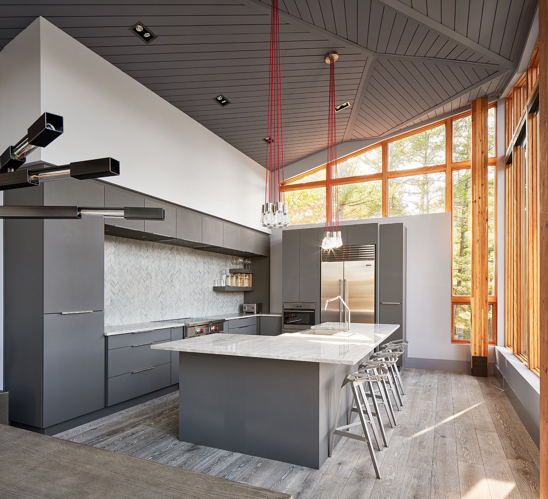 an interior view with midcentury modern furniture and northern wide wood planks on the floor