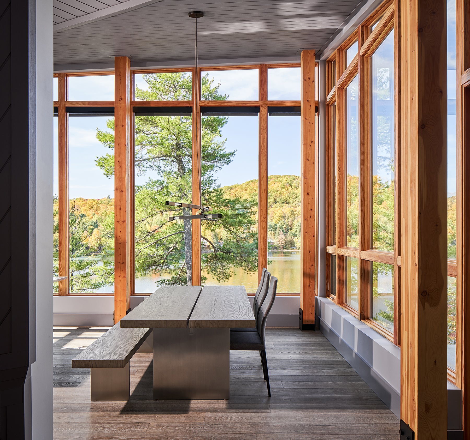 an interior view with midcentury modern furniture and northern wide wood planks on the floor