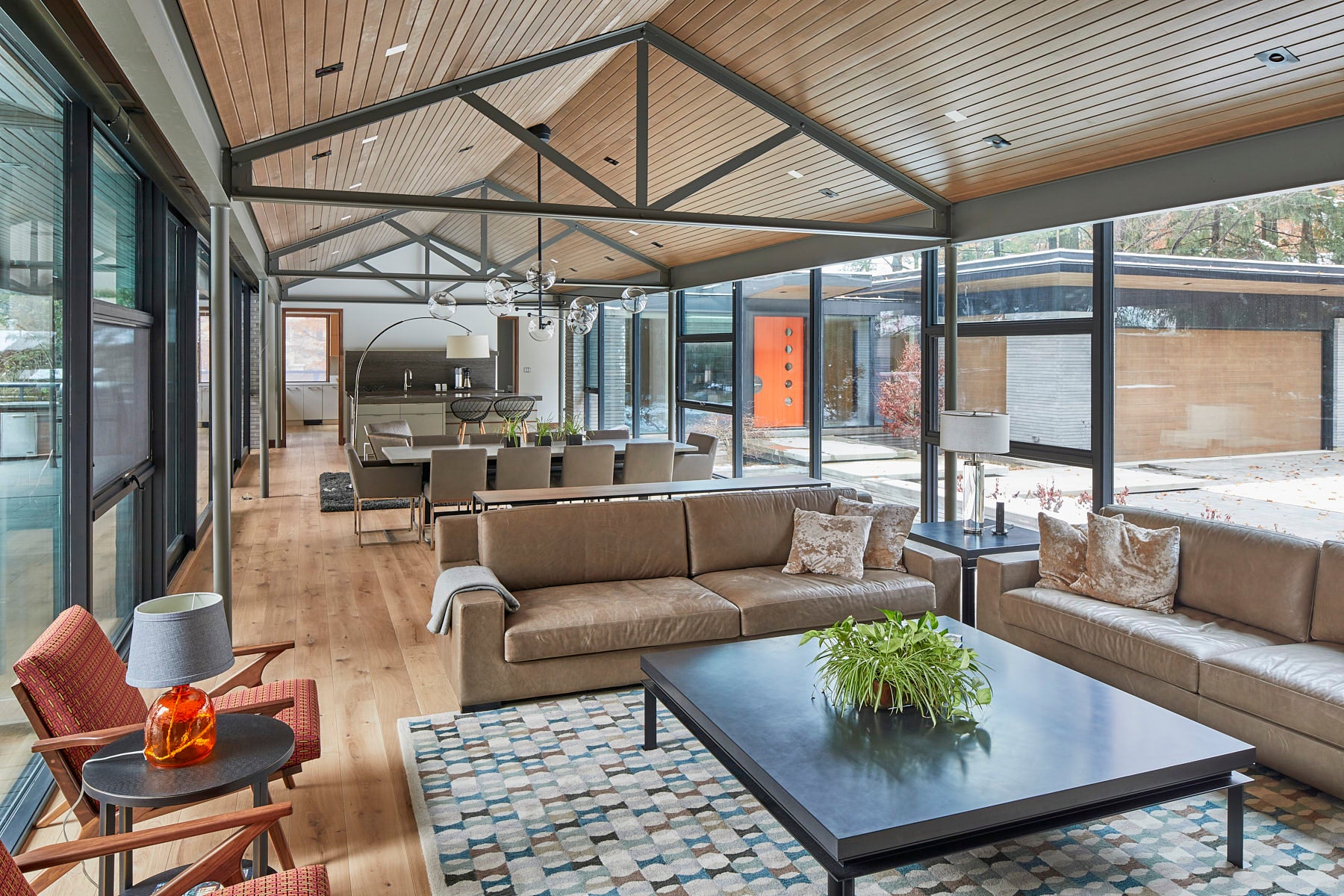 an interior view with midcentury modern furniture and northern wide wood planks on the floor