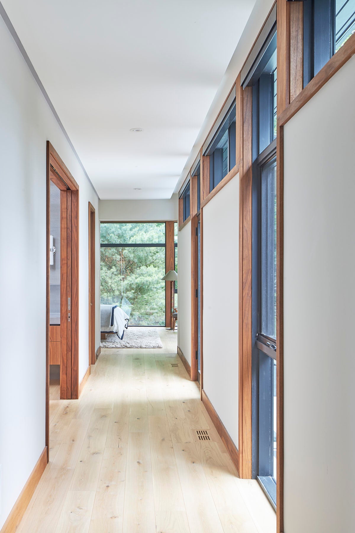 an interior view with midcentury modern furniture and northern wide wood planks on the floor