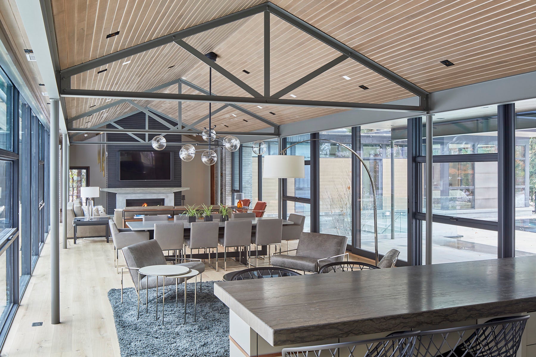 an interior view with midcentury modern furniture and northern wide wood planks on the floor