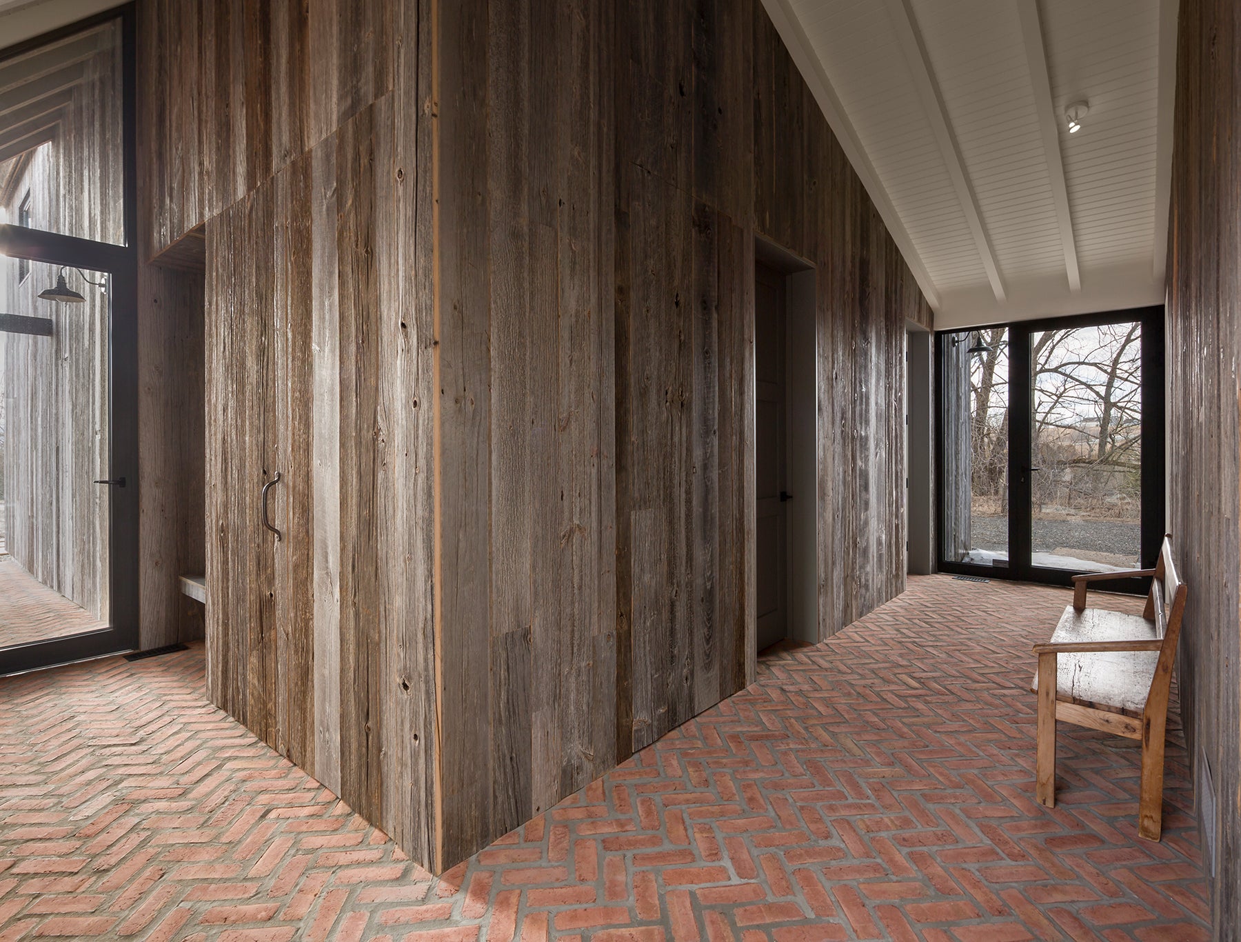 an interior view with midcentury modern furniture and northern wide wood planks on the floor