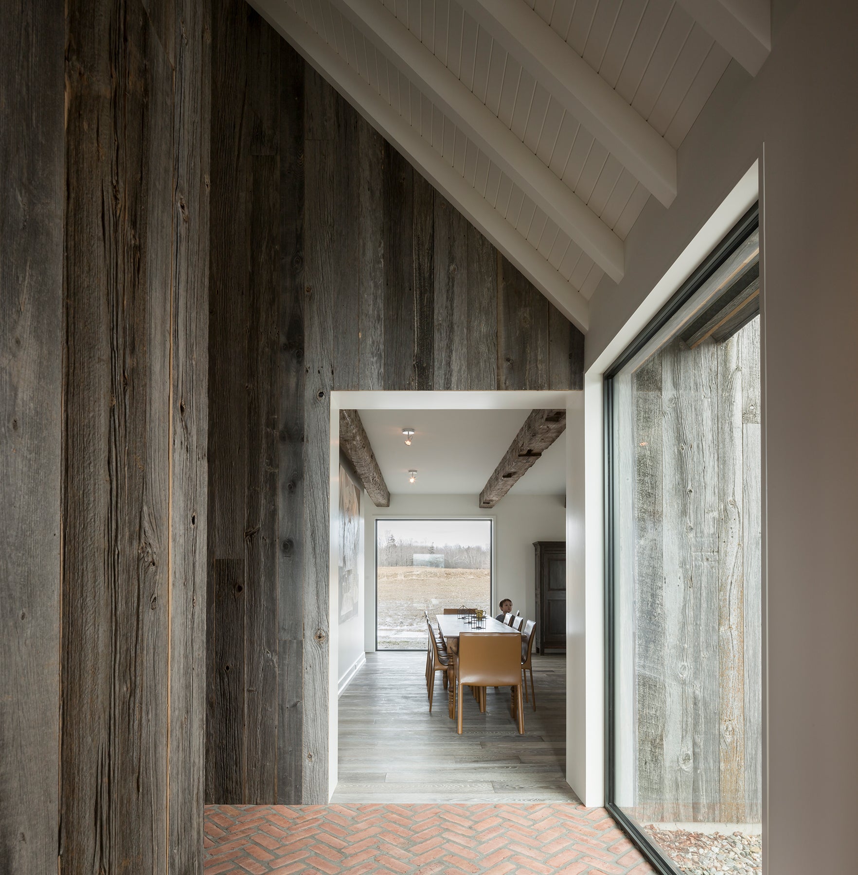 an interior view with midcentury modern furniture and northern wide wood planks on the floor