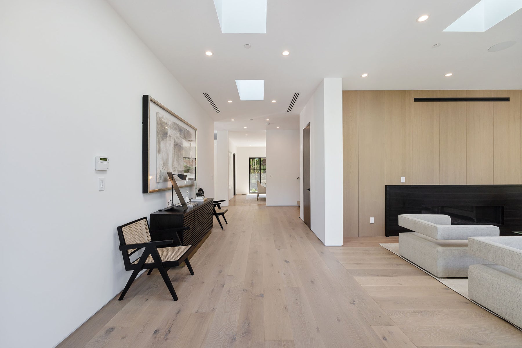 an interior view with midcentury modern furniture and northern wide wood planks on the floor