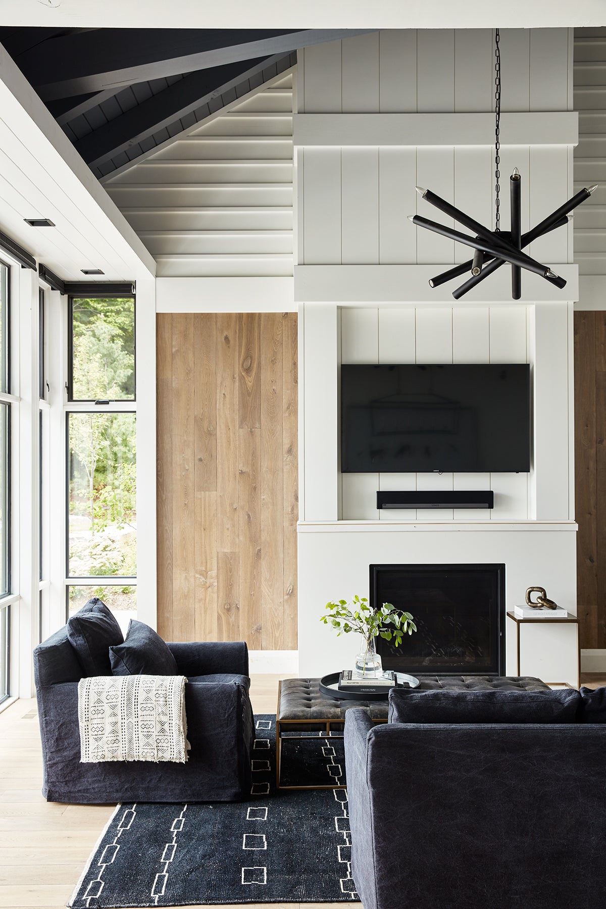 an interior view with midcentury modern furniture and northern wide wood planks on the floor