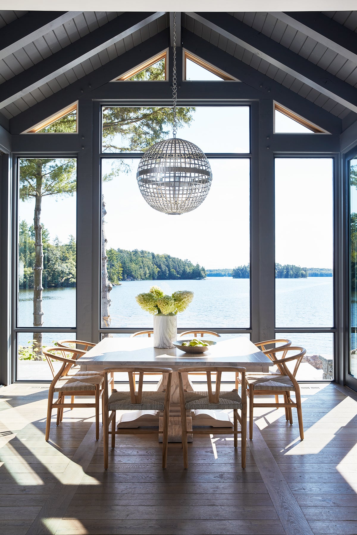 an interior view with midcentury modern furniture and northern wide wood planks on the floor