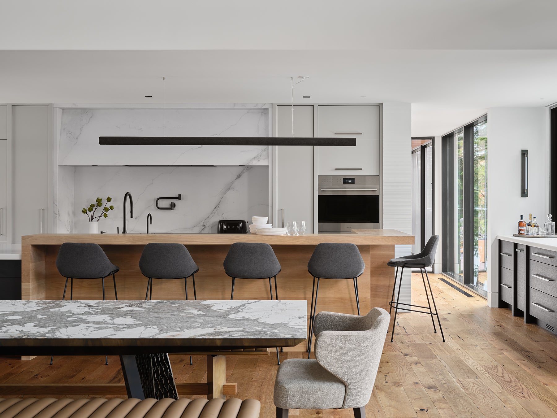 an interior view with midcentury modern furniture and northern wide wood planks on the floor