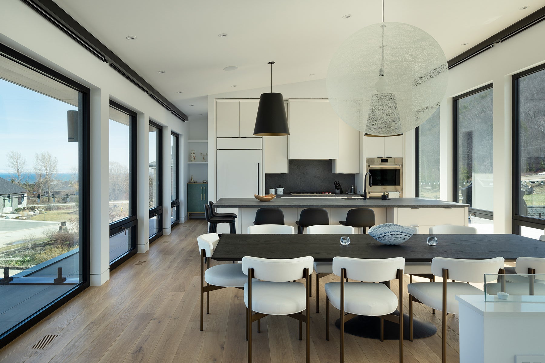 an interior view with midcentury modern furniture and northern wide wood planks on the floor