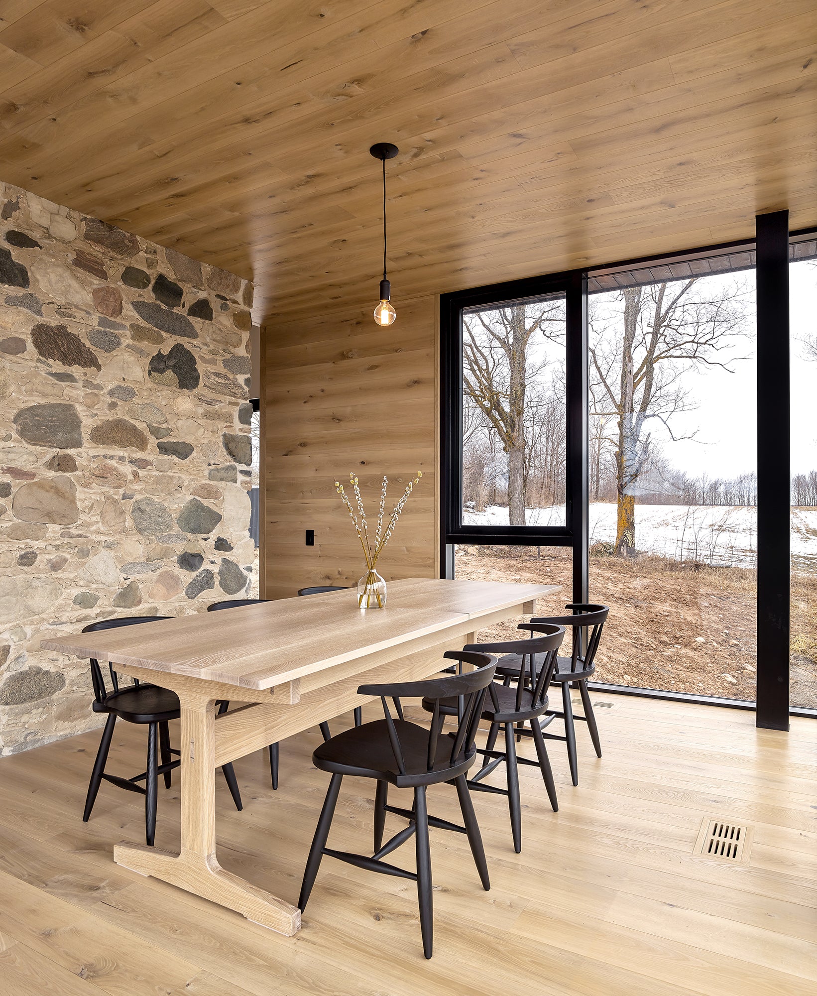 an interior view with midcentury modern furniture and northern wide wood planks on the floor