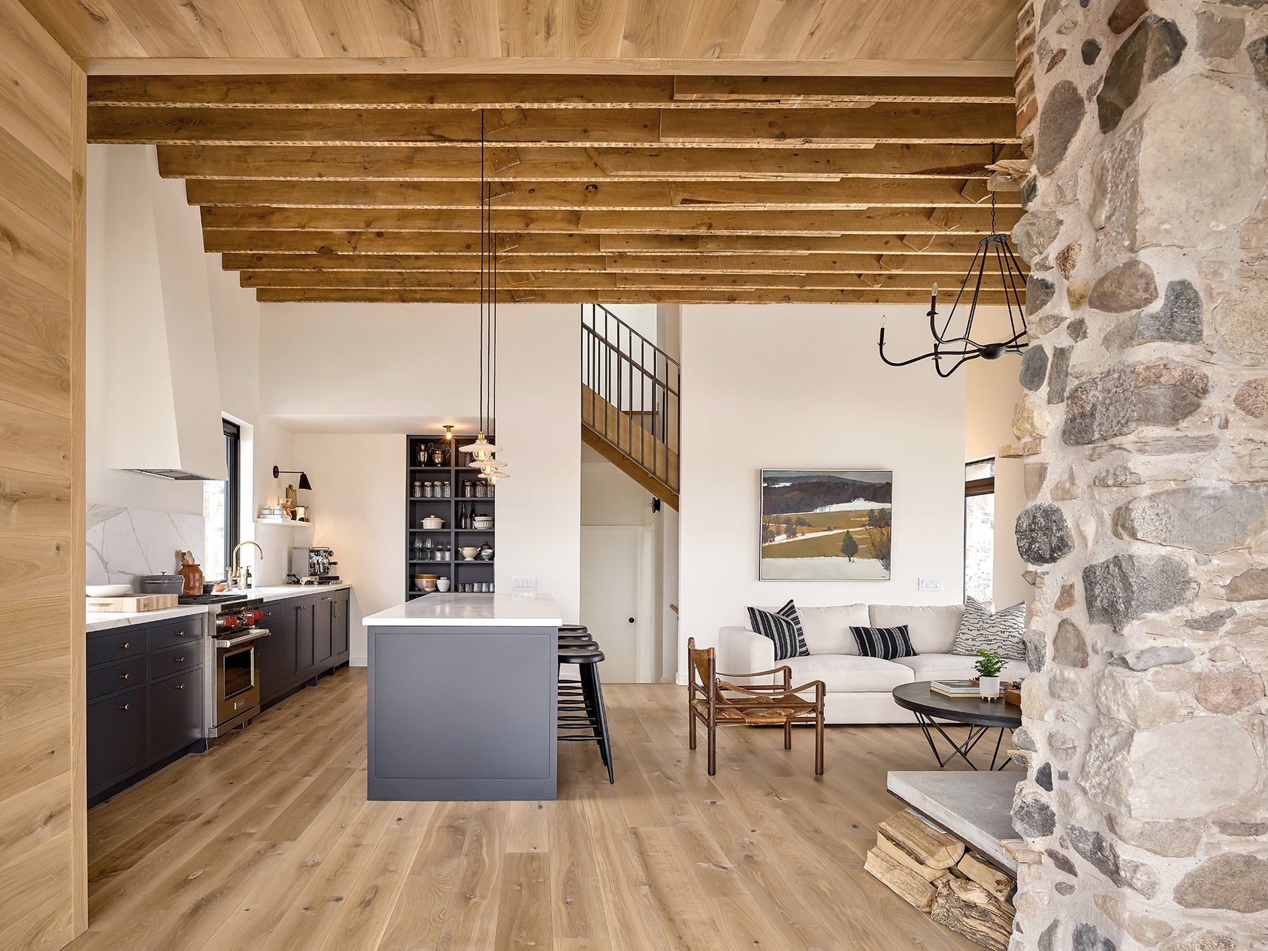 an interior view with midcentury modern furniture and northern wide wood planks on the floor