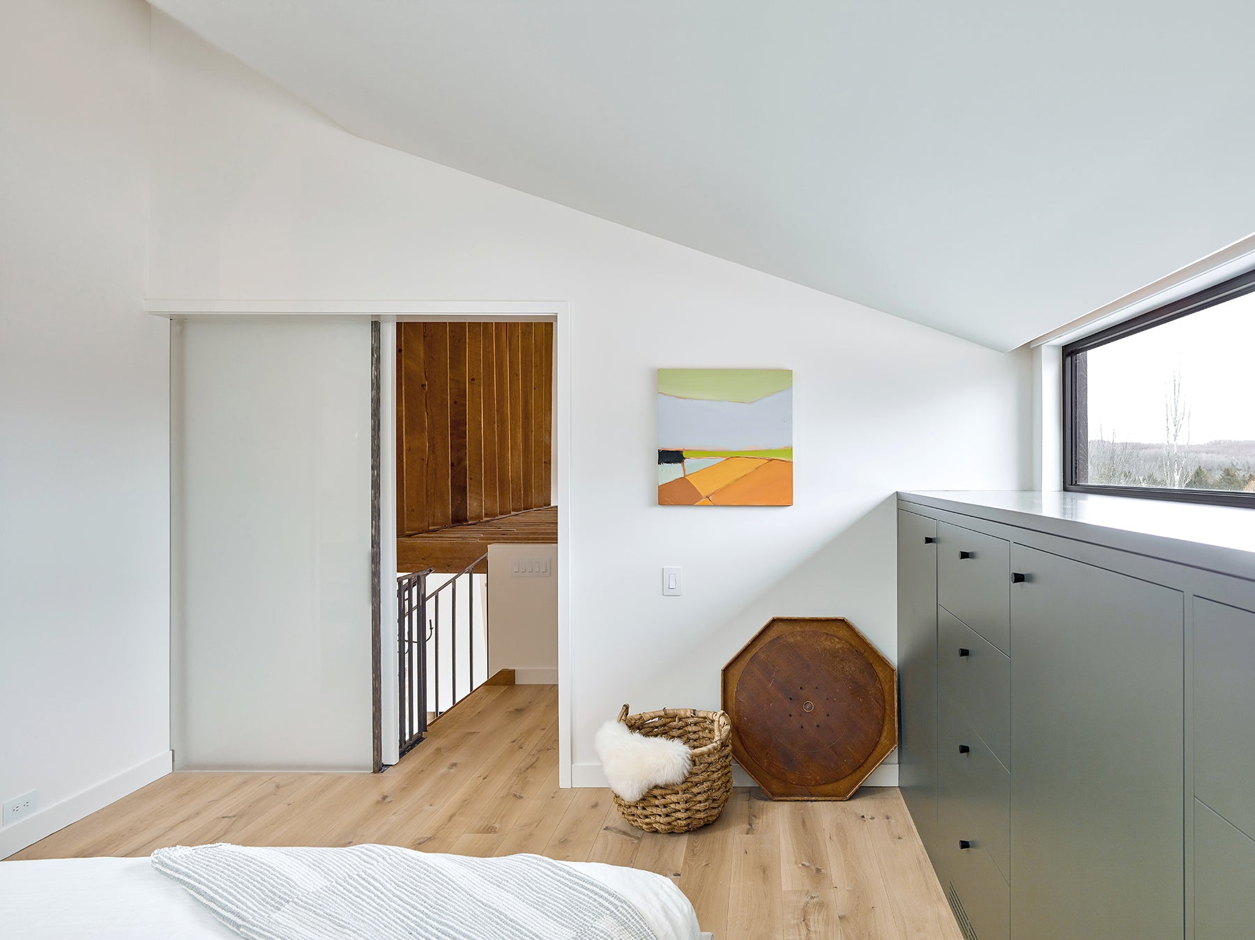 an interior view with midcentury modern furniture and northern wide wood planks on the floor