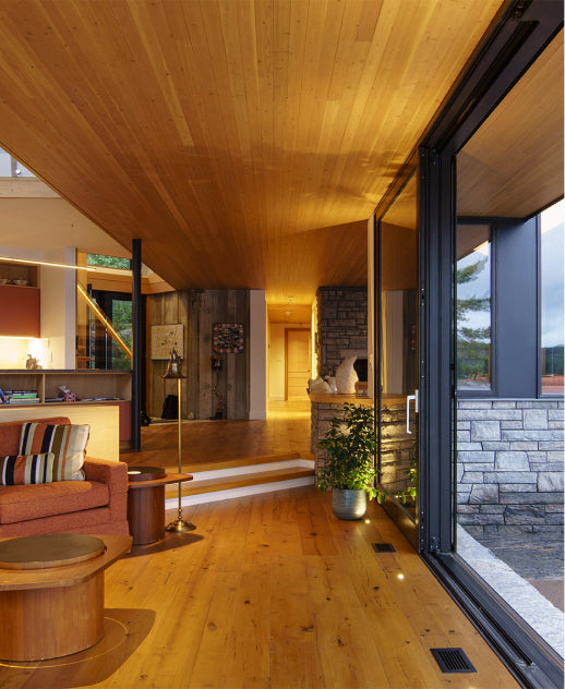 an interior view with midcentury modern furniture and northern wide wood planks on the floor