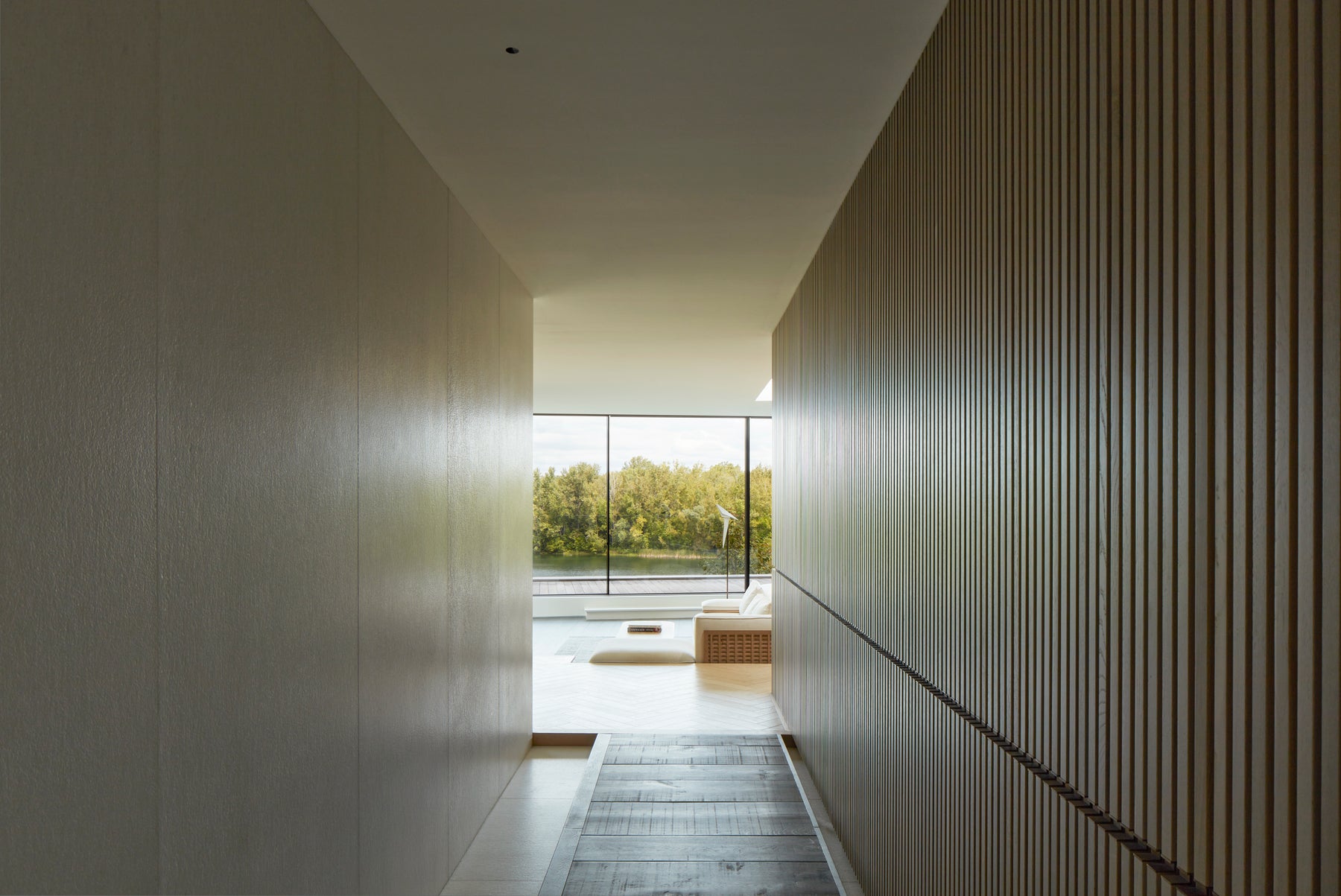 an interior view with midcentury modern furniture and northern wide wood planks on the floor