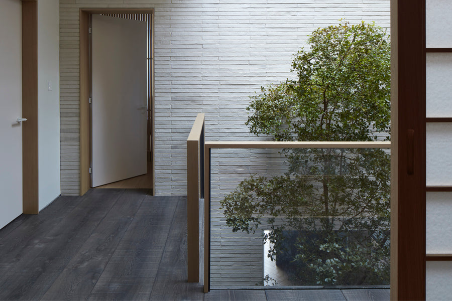 an interior view with midcentury modern furniture and northern wide wood planks on the floor