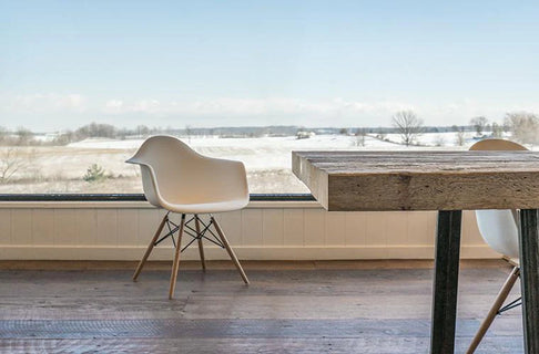 an interior view with midcentury modern furniture and northern wide wood planks on the floor