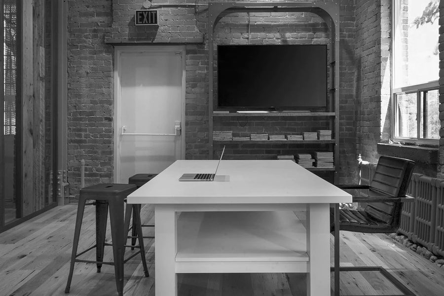 an interior view with midcentury modern furniture and northern wide wood planks on the floor