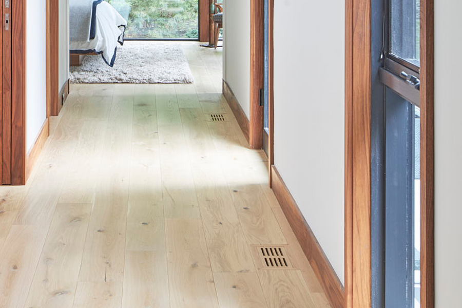 an interior view with midcentury modern furniture and northern wide wood planks on the floor