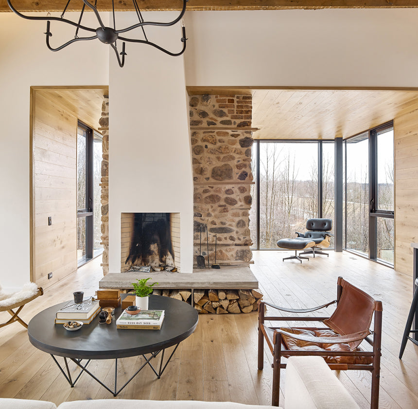 an interior view with midcentury modern furniture and northern wide wood planks on the floor